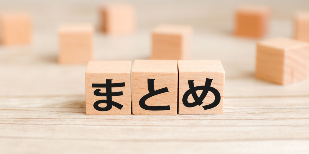 木製キューブ3個に黒文字で「まとめ」と並べ、背景にぼかしたブロックが点在する整理・総括のビジュアル