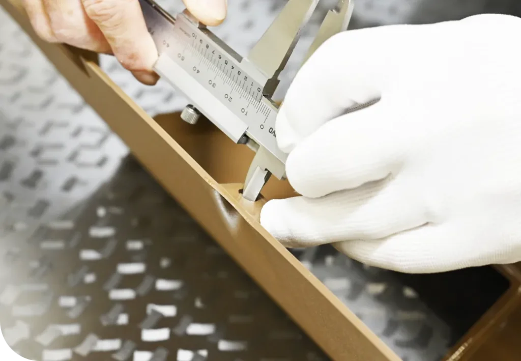 ノギスで金型のサイズを測る手元